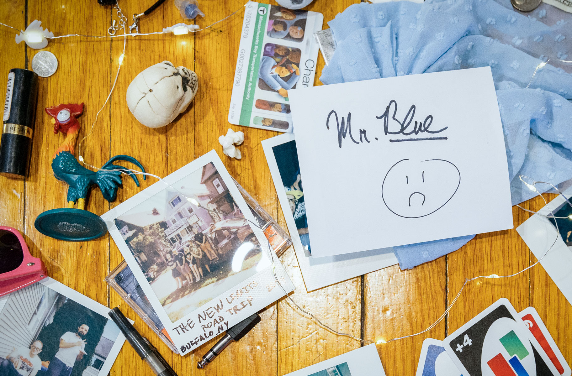 The artwork for the single, Mr. Blue, featuring a table strewn with various ephemera strewn across a bar by Boston ska band The New Limits.